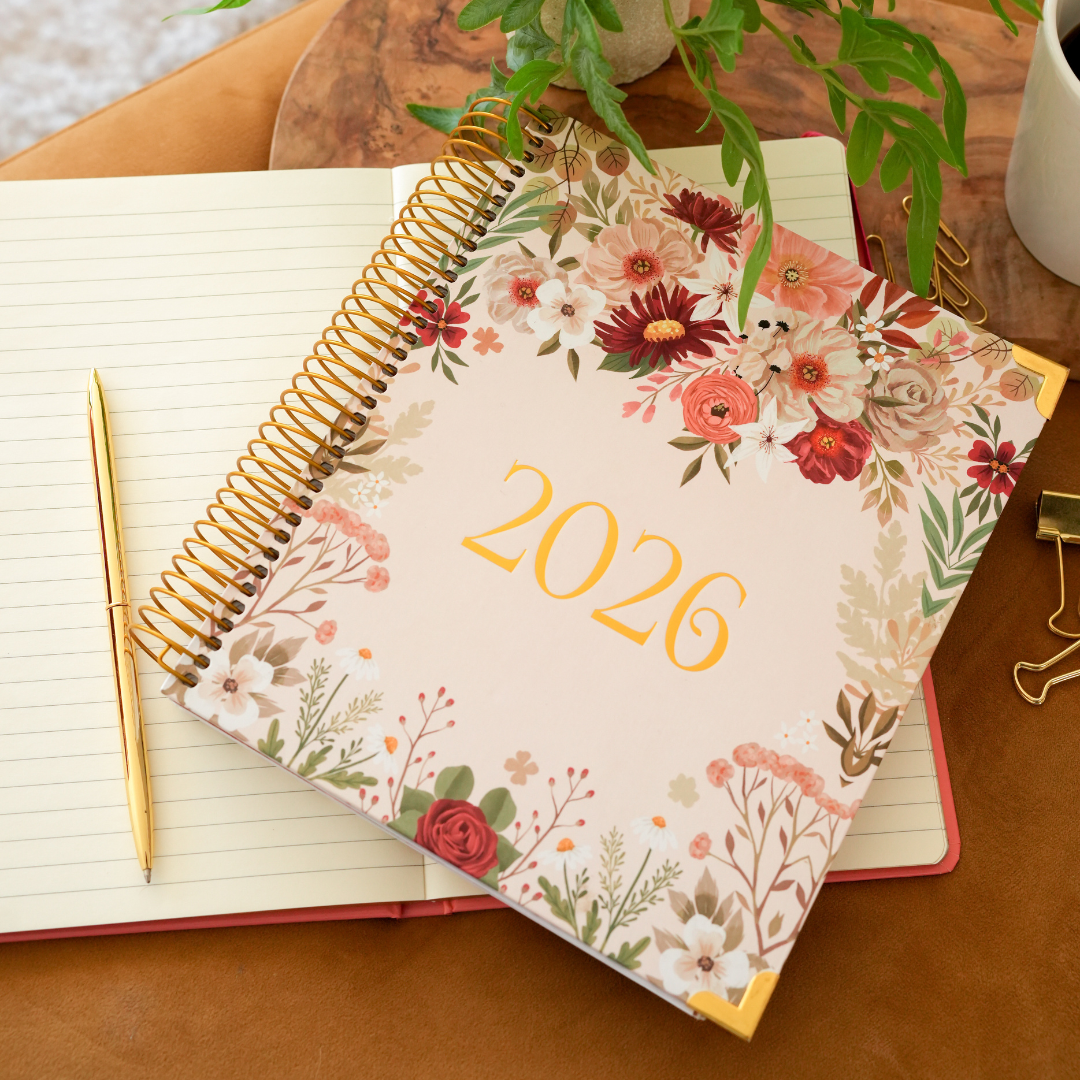 Flat lay of Atomic Mindset Budget Planner with pen and accessories on desk